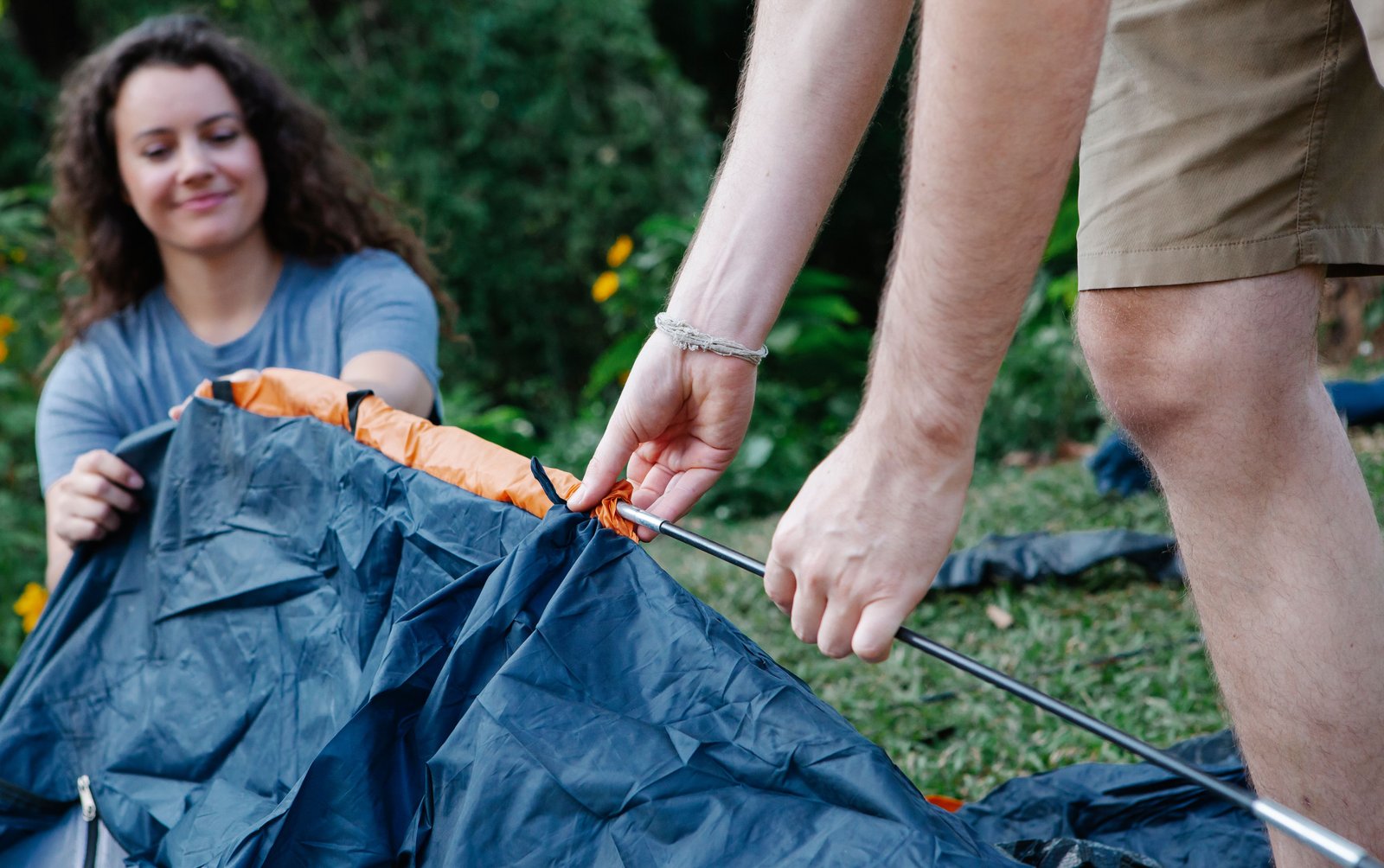 A couple setting up a tent